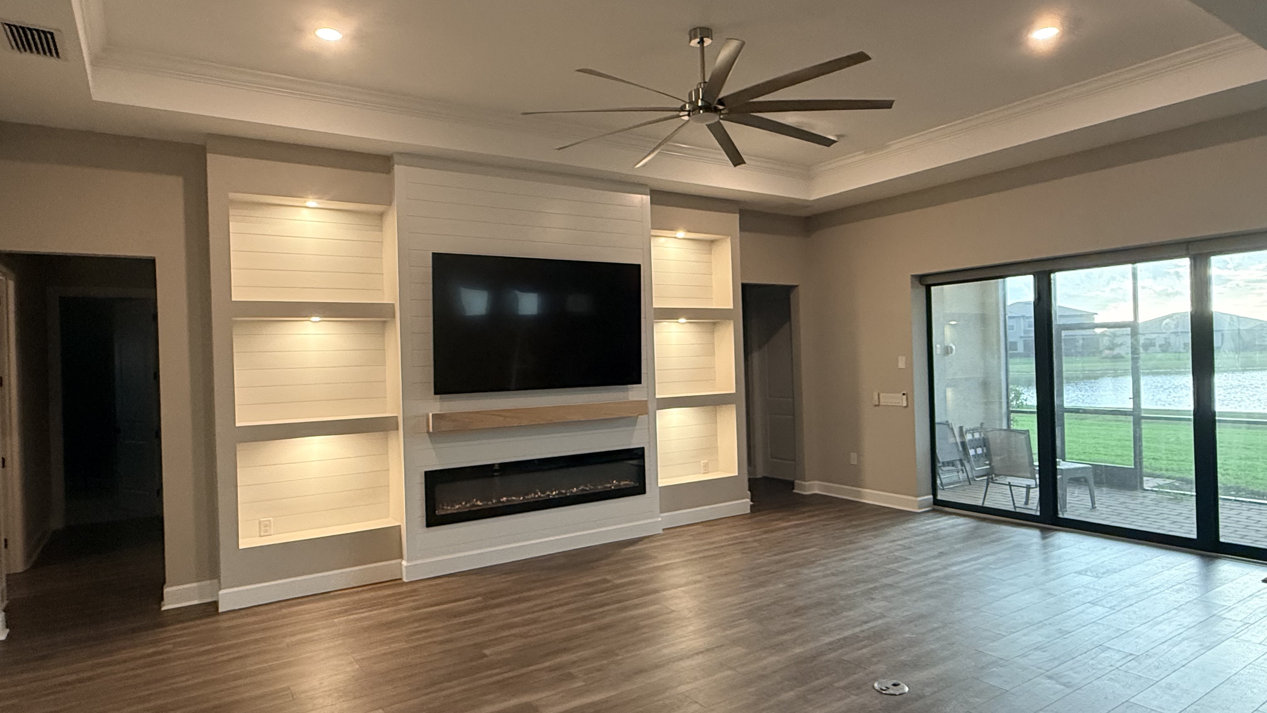 Custom TV wall with stone veneer and integrated fireplace