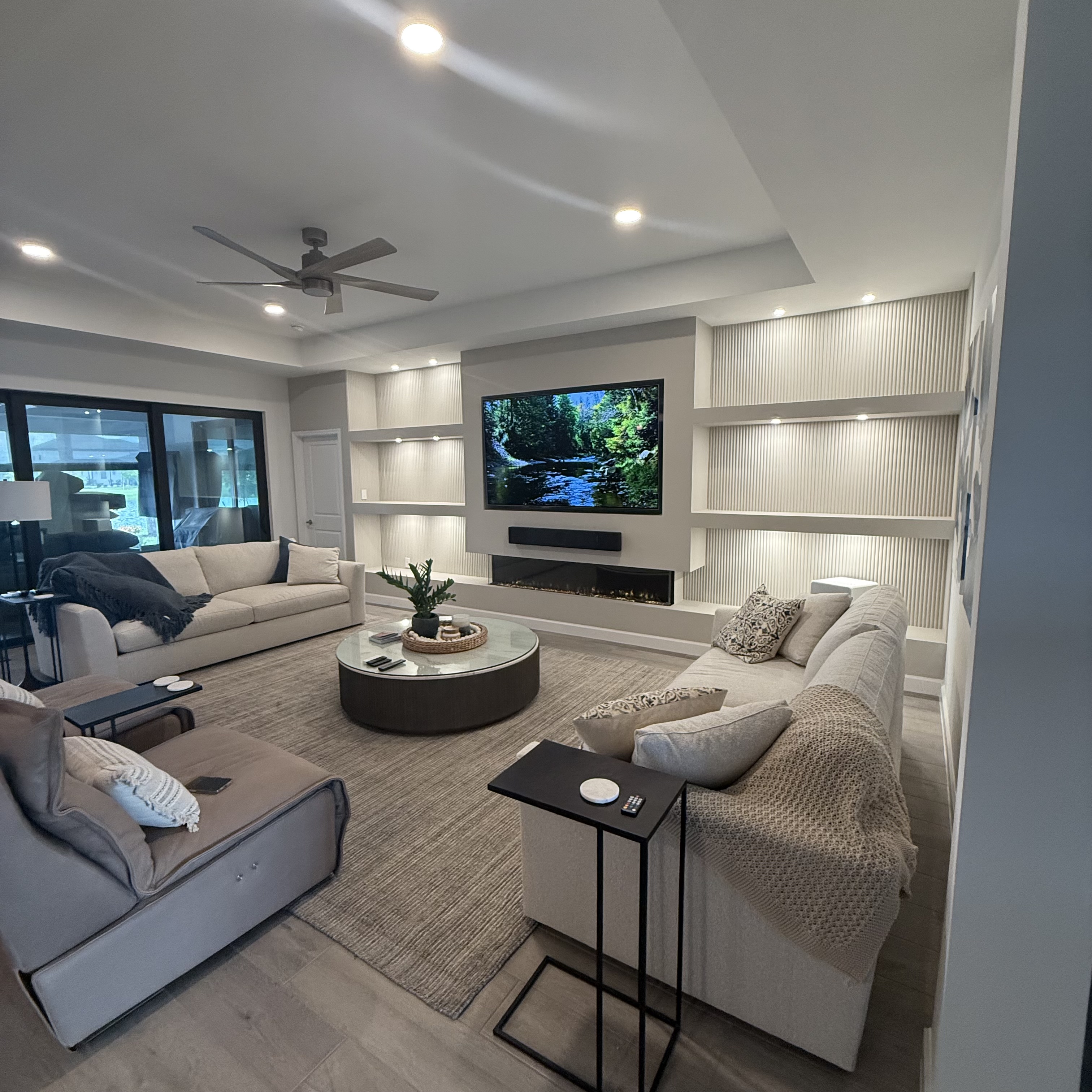 Entertainment wall with integrated shelving and warm ambient lighting