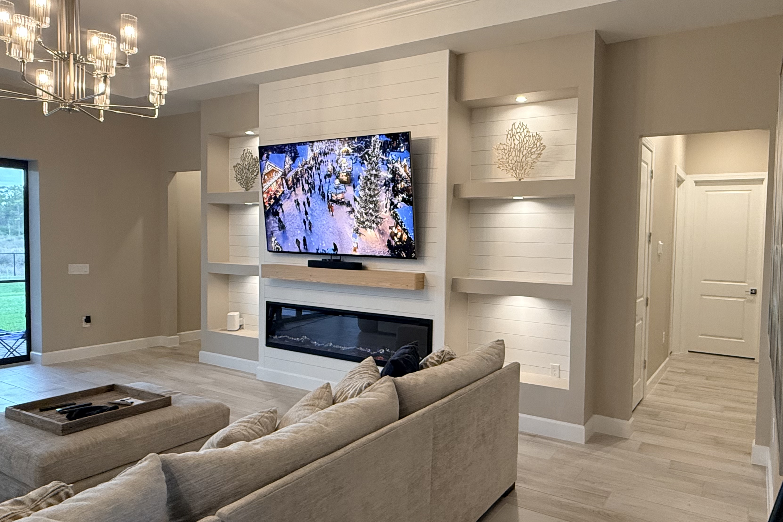 Custom TV wall with built-in storage and decorative lighting